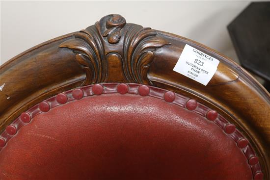 A Victorian red leather elbow chair